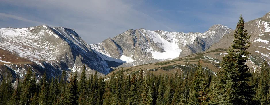 A snow-capped grey-rock mountain vista can be seen from the Mountain Research Station