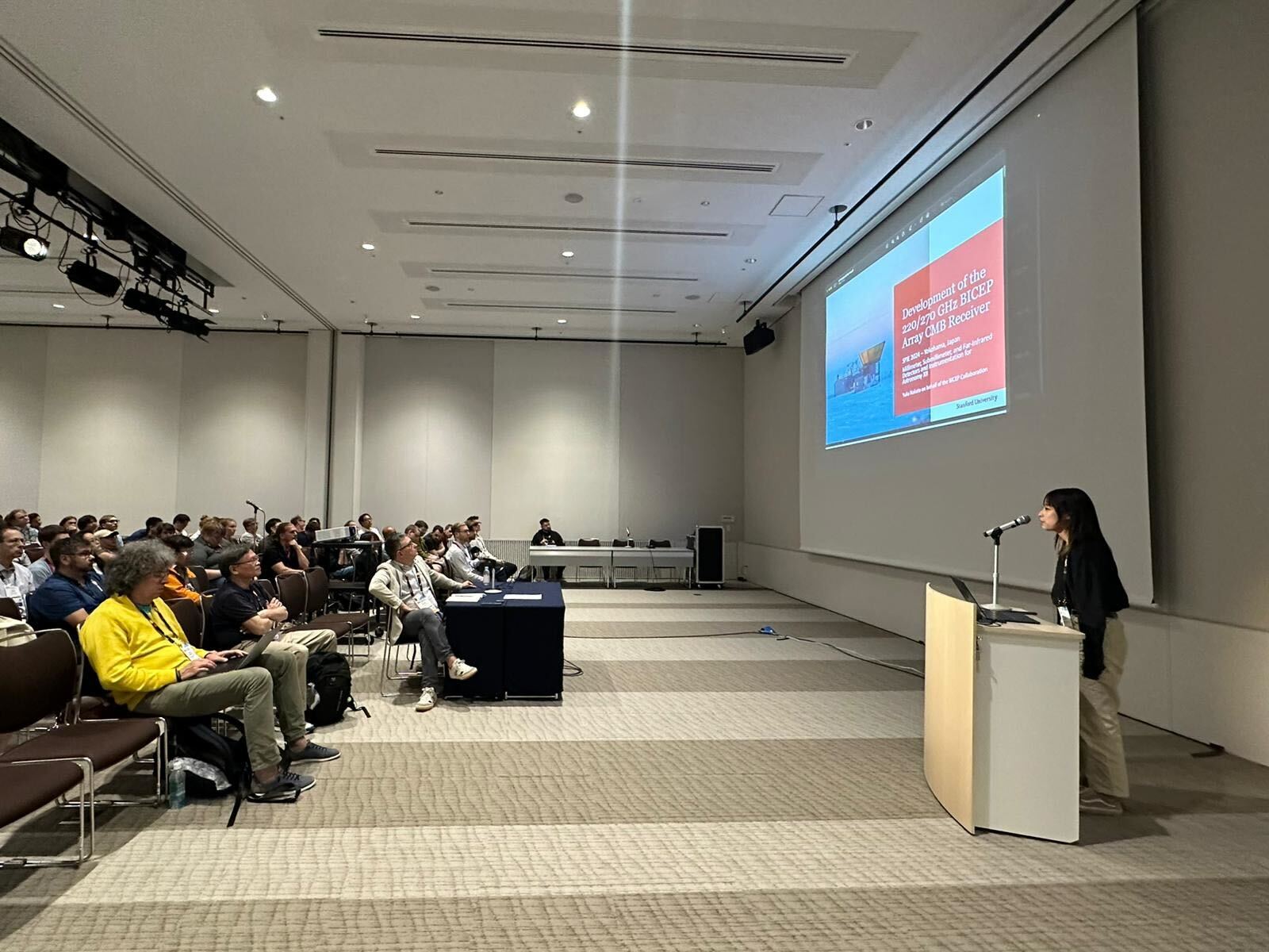Yuka Nakato presenting their research to a large group of people at SPIE