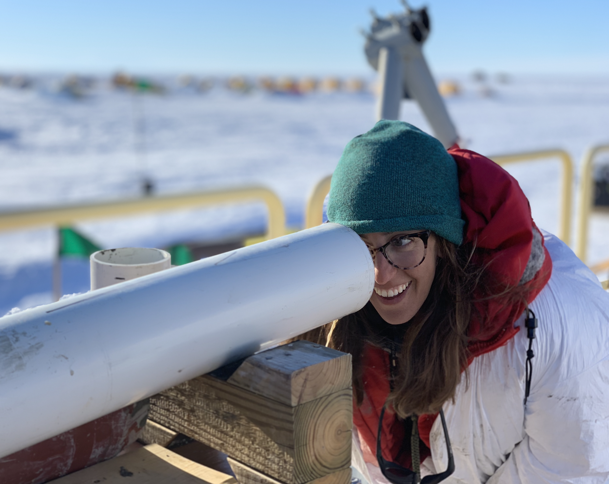 Ryan Venturelli looks into a coring tube at subglacial sediments that were part of the longest sediment core ever retrieved from an Antarctic subglacial lake 