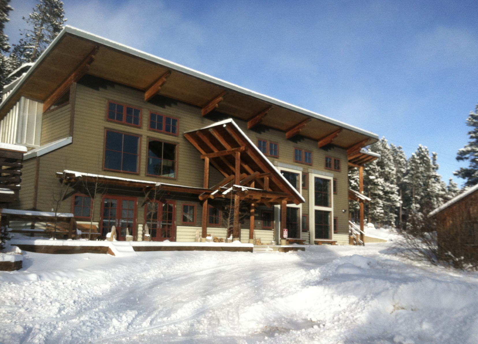 Moore's Mountain Lodge - a large wooden building is surrounded by snow, and depicts the lodging for the workshop