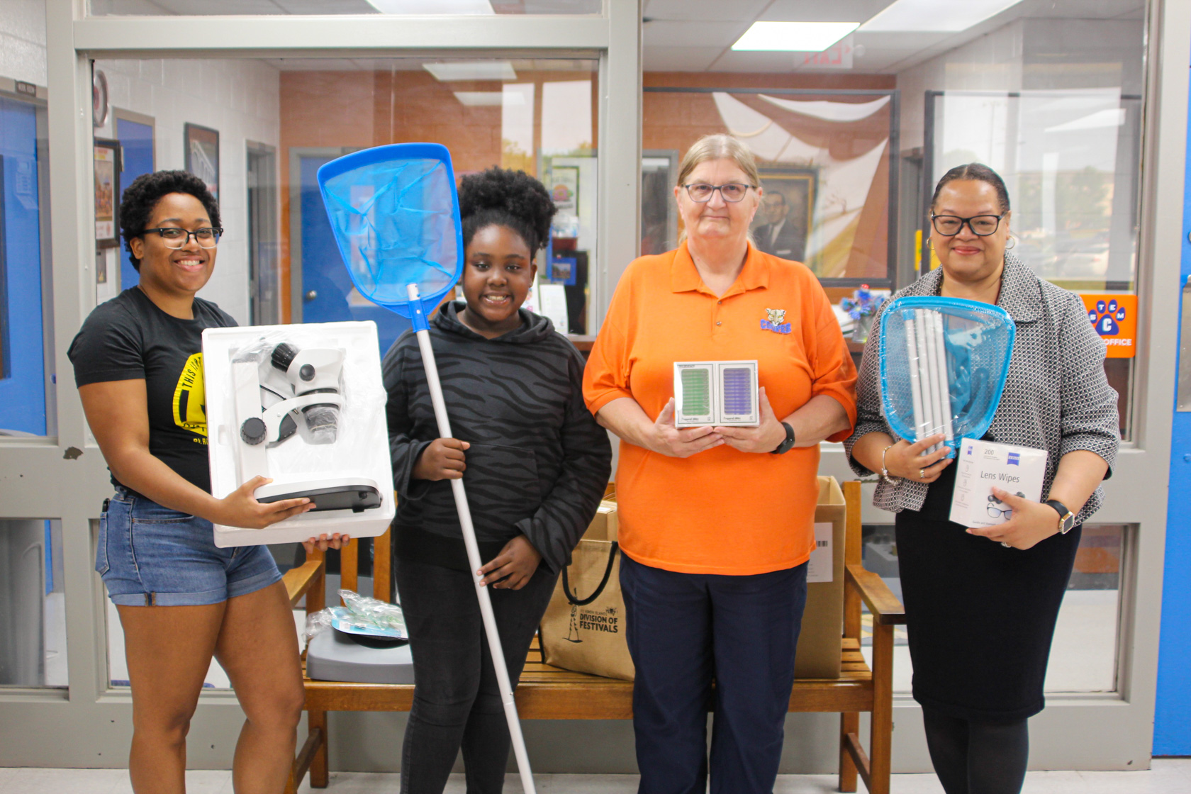 Students and Teachers show microscopes and other equipment