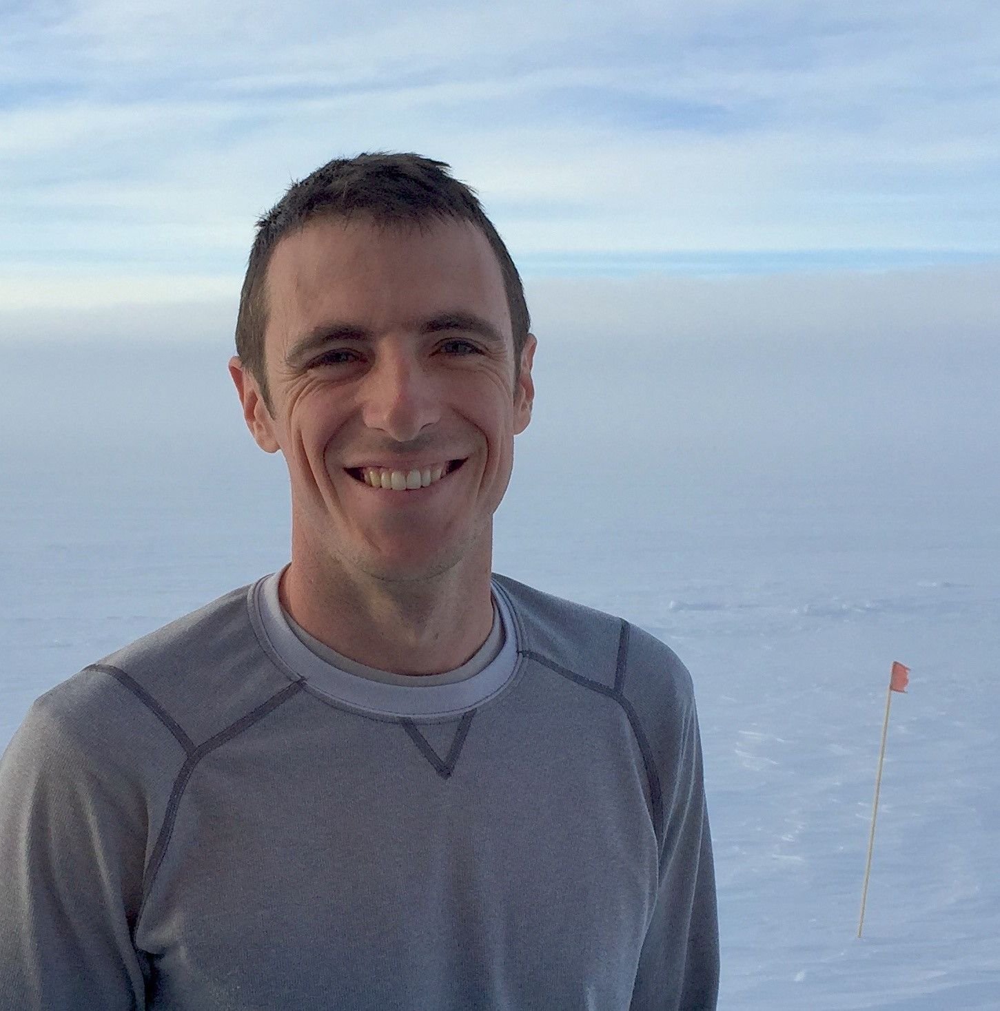 Sam smiles at the camera at Summit Station, Greenland