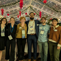 Polar Early Career Researcher Social organizers pose for a photo at the Rusty Nail in front of a web of twinkle lights. Pictures left to right includes: Madison Payne, Mariama Dryák-Vallies, Ellie Miller, Mohammed Afzal Shadab, Benjamin Maglio, and Neosha Narayanan. 