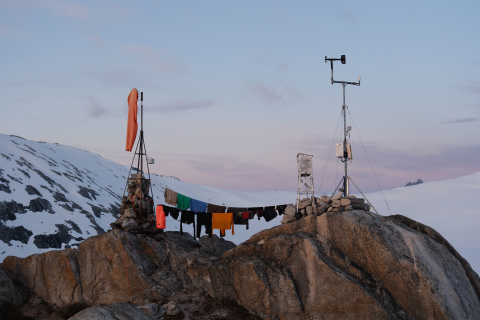 Camp blends science and daily life—where weather instruments, an anemometer, and a clothesline all share the same rocky perch.