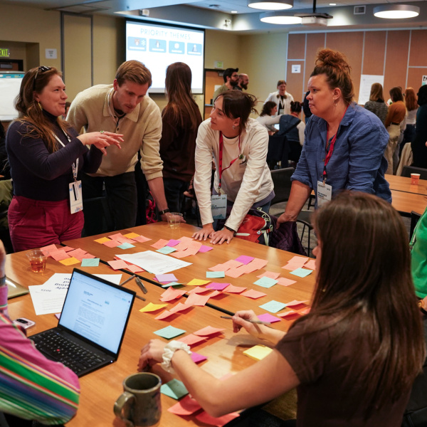 PECWS participants gather around a table and brainstorm ideas for priorities