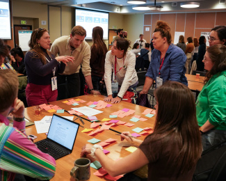 Early career scientists eagerly talk to one another at the Polar Early Career World Summit